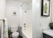 Thumbnail 8 of 36 - a bathroom with a shower and a toilet and a sink