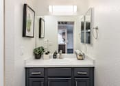 Thumbnail 7 of 36 - a bathroom with a sink and a mirror