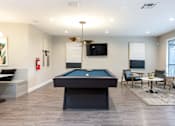 Thumbnail 23 of 36 - a game room with a pool table and a tv