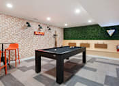 Thumbnail 34 of 42 - a game room with a pool table and a bar