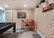 Thumbnail 35 of 42 - a game room with a pool table and orange chairs