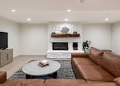Thumbnail 37 of 42 - a living room with a couch and a coffee table and a fireplace