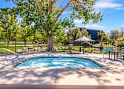 Thumbnail 25 of 42 - a hot tub with trees and a fence around it