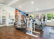 Thumbnail 30 of 42 - a home gym with exercise equipment and a mural on the wall