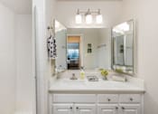 Thumbnail 9 of 42 - a bathroom with a sink and a shower and a mirror