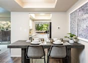 Thumbnail 4 of 42 - a kitchen and dining room with a table and chairs