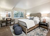Thumbnail 7 of 42 - a bedroom with a bed and a round window