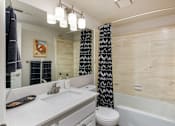 Thumbnail 11 of 42 - a bathroom with a sink and a toilet and a tub