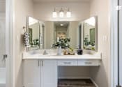 Thumbnail 21 of 42 - a bathroom with a sink and a mirror