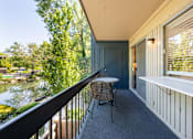 Thumbnail 27 of 42 - a balcony with a table and chairs and a river