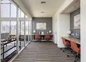 Thumbnail 29 of 38 - a conference room with a desk and chairs and a window