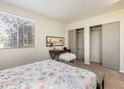 Thumbnail 16 of 38 - a bedroom with a bed and two closets and a window