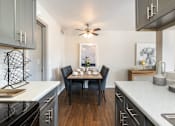 Thumbnail 3 of 38 - an open kitchen with a dining table and a ceiling fan