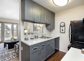 Thumbnail 4 of 38 - an open kitchen with a sink and a refrigerator