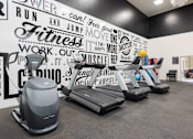 Thumbnail 23 of 38 - a gym with weights and a wall mural of gym equipment