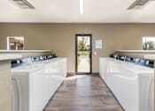 Thumbnail 38 of 38 - a row of washers and dryers in a laundry room
