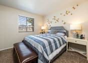 Thumbnail 6 of 38 - a bedroom with a blue and white bed and a window