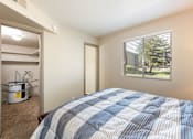 Thumbnail 7 of 38 - a bedroom with a bed and a closet with a window