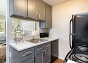 Thumbnail 14 of 38 - a kitchen with a sink and refrigerator and a window