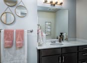 Thumbnail 10 of 42 - a bathroom with a sink and a mirror and a towel rack