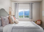 Thumbnail 6 of 42 - a bedroom with a bed and a window with a mountain view