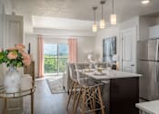 Thumbnail 1 of 42 - an open kitchen and dining room with stainless steel appliances and a table with chairs