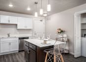 Thumbnail 4 of 42 - a kitchen with white cabinets and a counter top