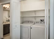 Thumbnail 11 of 42 - a white washer and dryer in a white laundry room