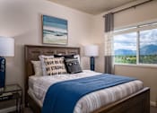 Thumbnail 16 of 42 - a bedroom with a bed and a window with mountain views
