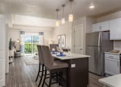 Thumbnail 12 of 42 - an open kitchen and dining area with a stainless steel refrigerator