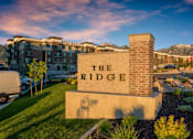 Thumbnail 21 of 42 - the ridge condominiums building sign in front of lawn and buildings