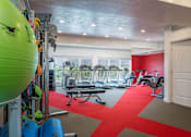 Thumbnail 27 of 42 - a gym with chairs and equipment in a room with windows