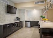 Thumbnail 33 of 42 - a kitchen with stainless steel appliances and a large counter top