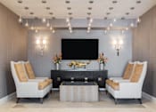 Thumbnail 32 of 42 - a lobby with chairs and a television