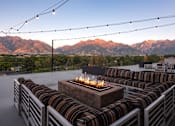 Thumbnail 37 of 42 - a fire pit on a patio with mountains in the background