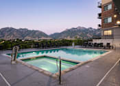 Thumbnail 35 of 42 - a swimming pool at a hotel with mountains in the background