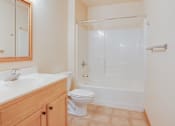 Thumbnail 11 of 16 - A white toilet sits next to a sink in a bathroom, Kassenborg Apartments, Moorhead, MN, 56560