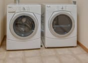 Thumbnail 12 of 16 - Two white front loading washing machines in a laundry room, Kassenborg Apartments, Moorhead, MN, 56560