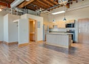 Thumbnail 3 of 16 - A kitchen area with wooden floors and a counter, Kassenborg Apartments, Moorhead, MN, 56560