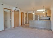 Thumbnail 5 of 16 - A kitchen area with a refrigerator, cabinets, and a countertop, Kassenborg Apartments, Moorhead, Minnesota, 56560