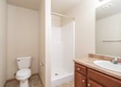 Thumbnail 7 of 9 - a bathroom with a toilet and a sink and a shower at Benson Village Townhomes Apartments, Sioux Falls