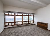 Thumbnail 5 of 7 - A room with a large window and a radiator on the wall at Block 6 Apartments, Fargo, ND, 58103