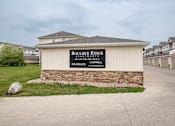 Thumbnail 8 of 8 - a building with a sign that says boulder river apartments at Boulder Ridge Apartments, North Dakota