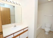 Thumbnail 5 of 6 - A white toilet sits in a bathroom next to a sink.
