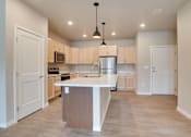 Thumbnail 2 of 11 - a large kitchen with an island in the middle, Pinehurst Apartments, Baxter, MN