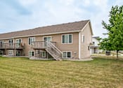 Thumbnail 4 of 13 - Backyard Green Lawn at The Pines Townhomes, North Dakota