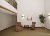 Thumbnail 3 of 5 - a living room with two chairs and a table and a potted plant Pinewood Estates, Zimmerman, MN