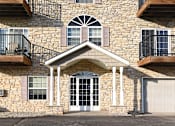 Thumbnail 1 of 5 - the front of a brick house with a white garage door Pinewood Estates, Zimmerman, 55398