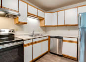 Thumbnail 3 of 9 - Kitchen with stainless steel appliances at Redwood Estates, Coon Rapids, Minnesota, 55433