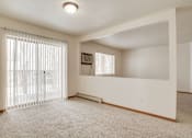 Thumbnail 4 of 9 - A room with a window covered by white blinds and a carpet on the floor.
